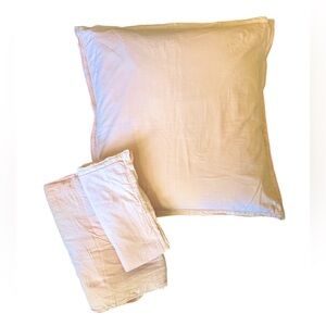 DKNY Bedding set. Two peach euro shams and one queen bed skirt